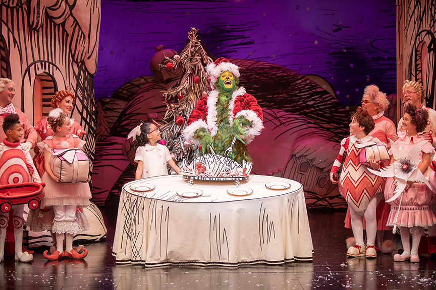 (center) Sophia Adajar as Cindy-Lou Who and Edward Watts as The Grinch with the cast of Dr. Seuss's How the Grinch Stole Christmas!, book and lyrics by Timothy Mason, music by Mel Marvin, original production conceived and directed by Jack O'Brien, original choreography by John DeLuca, and directed by James Vásquez, running November 10 – December 29, 2019 at The Old Globe. Photo by Jim Cox.