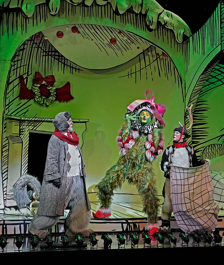 (from left) Steve Gunderson appears as Old Max, Edward Watts as The Grinch, and Tommy Martinez as Young Max in Dr. Seuss's How the Grinch Stole Christmas!, book and lyrics by Timothy Mason, music by Mel Marvin, original production conceived and directed by Jack O'Brien, original choreography by John DeLuca, and directed by James Vásquez, running November 3 – December 29, 2018 at The Old Globe. Photo by Ken Howard.